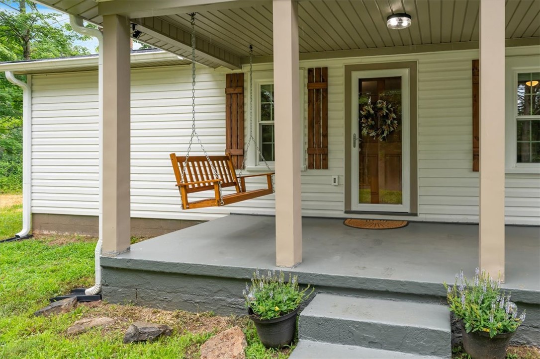 174 Holliday Road Six Mile, SC 29682 - Photo 1 of 49 A welcoming front porch features a classic wooden swing