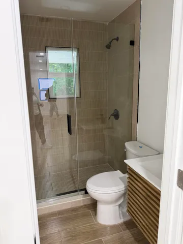 a white toilet sitting next to a sink
