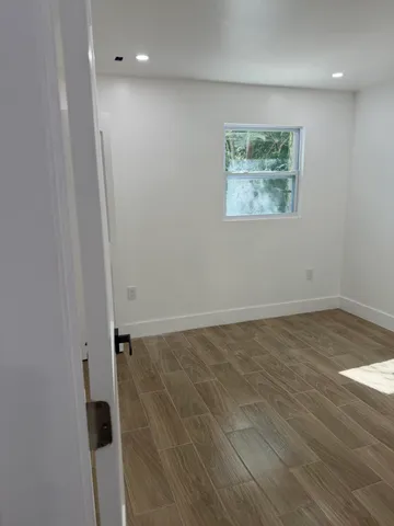 a view of a backyard with large tree