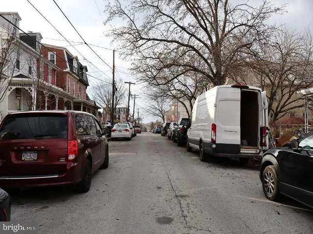 a view of a cars park in front of a house