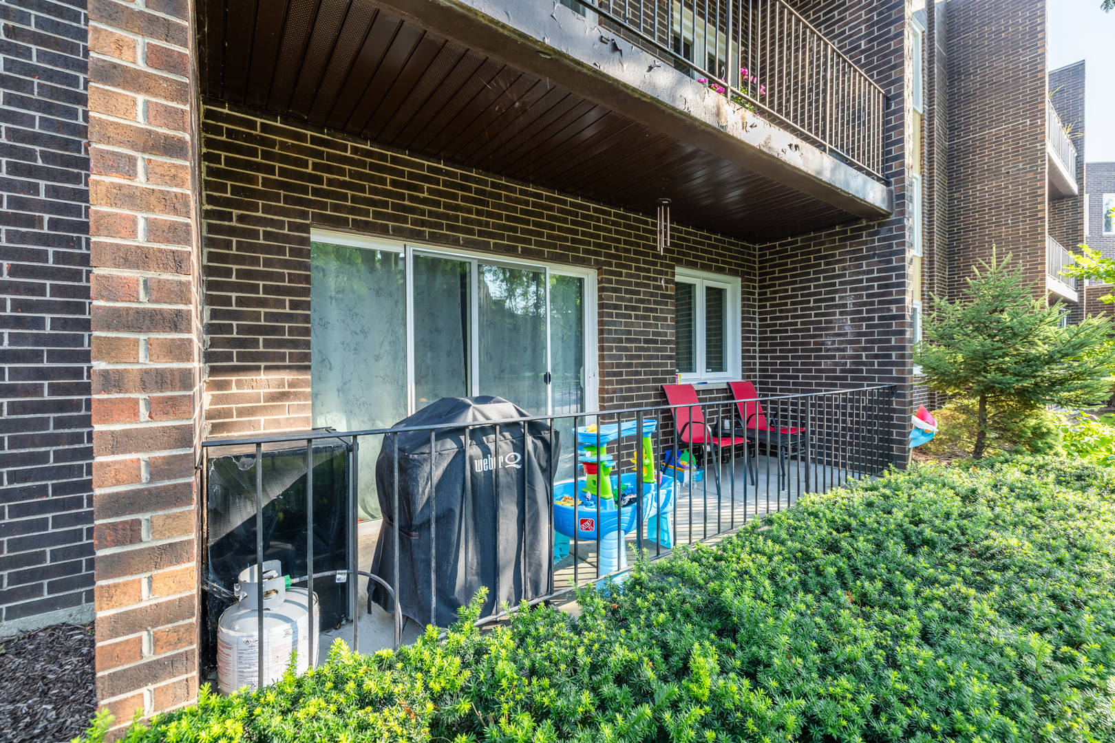 1525 Sander Court, Unit 103 Wheeling, IL 60090 - Photo 25 of 28 a view of front door of house and car parked