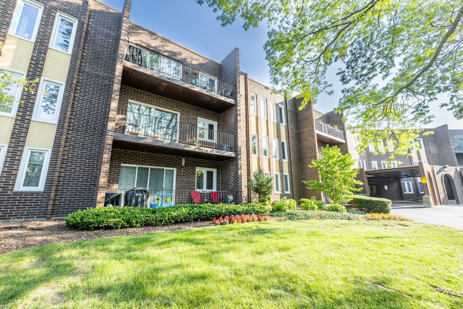 1525 Sander Court, Unit 103 Wheeling, IL 60090 - Photo 4 of 28 a view of a building with a yard