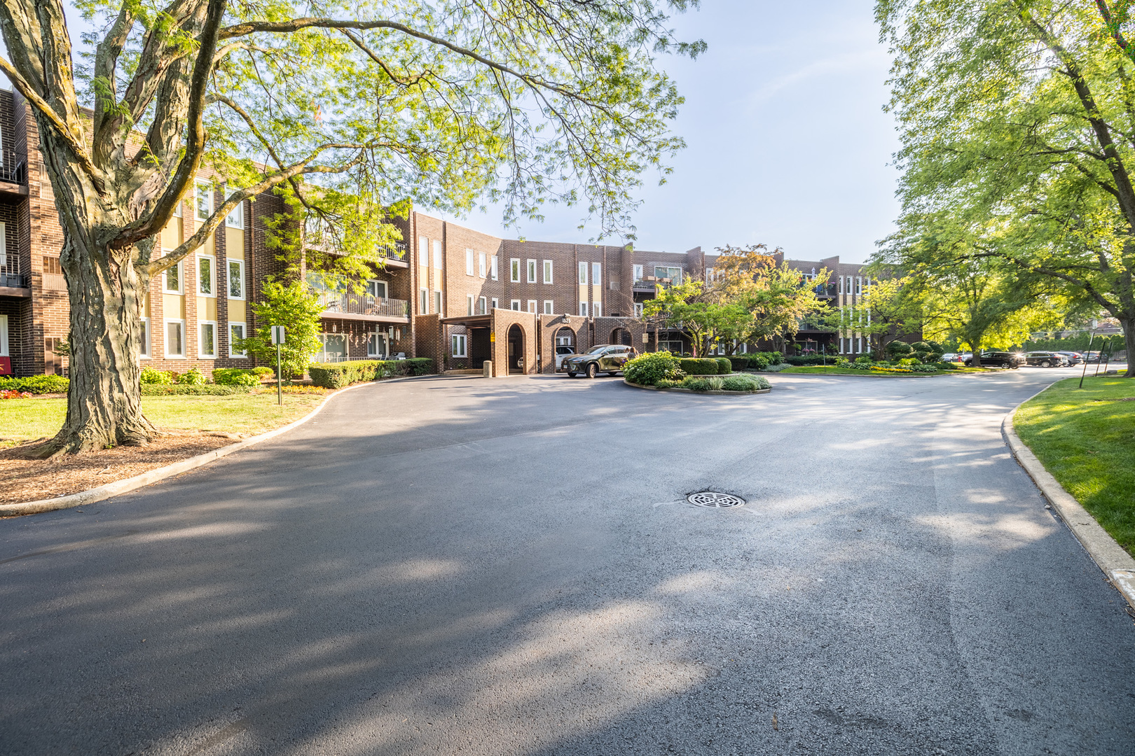 1525 Sander Court, Unit 103 Wheeling, IL 60090 - Photo 5 of 28 a view of a street with a building and trees in the background