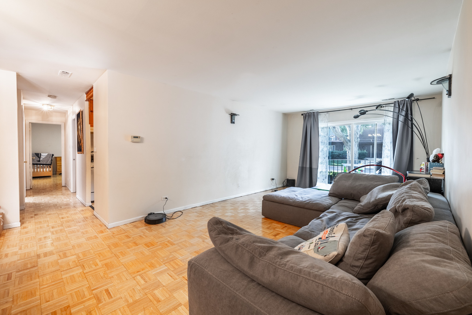 1525 Sander Court, Unit 103 Wheeling, IL 60090 - Photo 10 of 28 a living room with a couch and a window