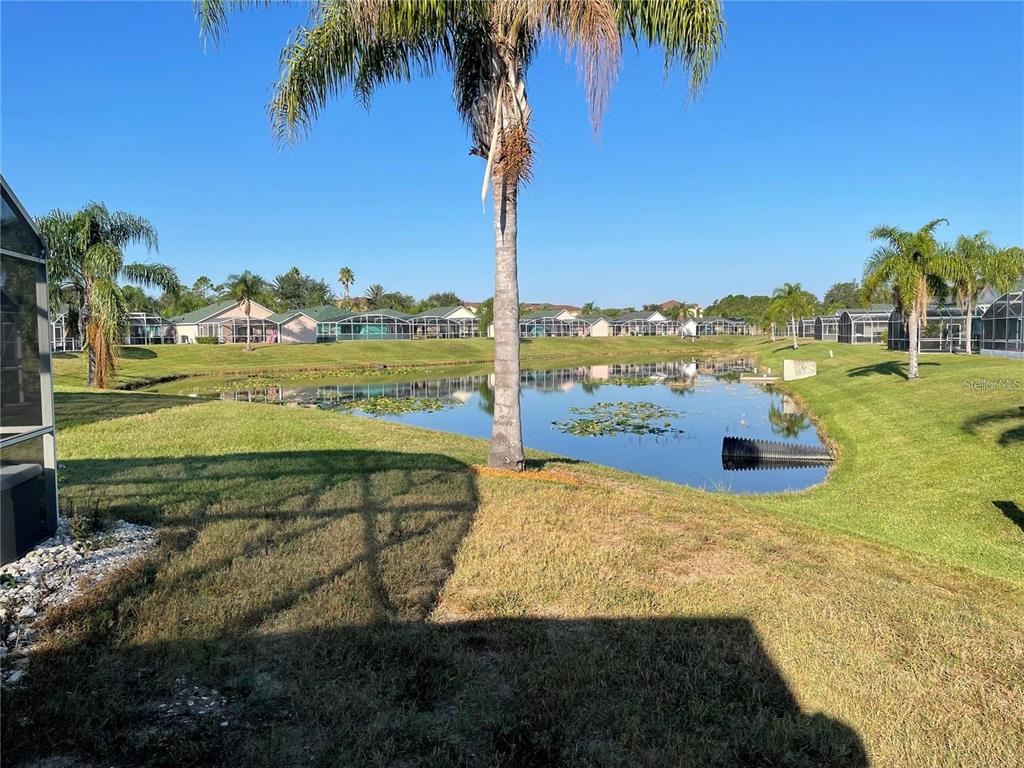 927 Reserve Place Davenport, FL 33896 - Photo 18 of 18 a view of a lake with a big yard