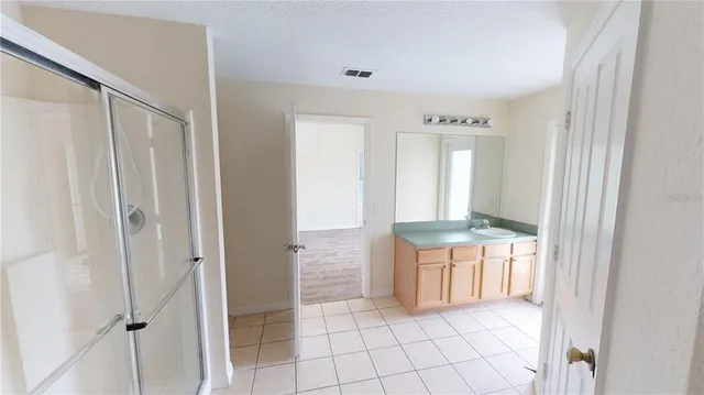 a bathroom with a tub shower and a sink