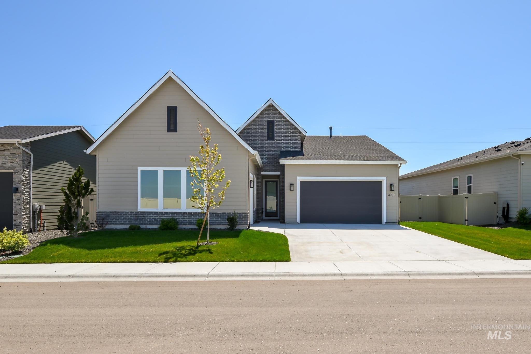 320 Orrison Street Caldwell, ID 83607 - Photo 1 of 1 View of front of house featuring a front lawn, an attached garage, driveway, and a gate