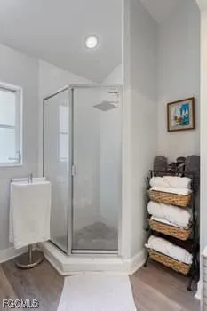a view of a bedroom with baby bed and lounge chair
