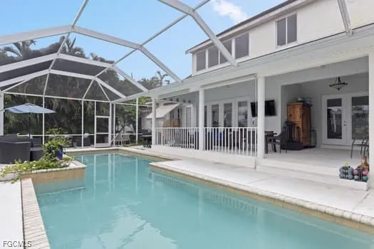 a view of a house with pool and sitting area
