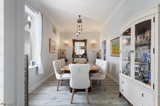 a dining room with furniture window and wooden floor