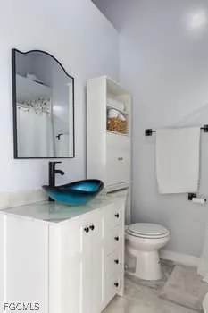 a bathroom with a toilet a sink and mirror
