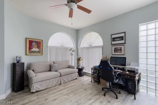 a living room with furniture a piano and a window