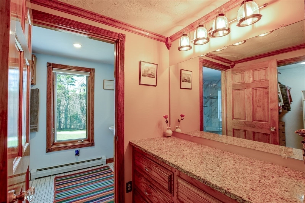 205 East Rindge Road Ashburnham, MA 01430 - Photo 26 of 40 a bathroom with a granite countertop sink and a large mirror