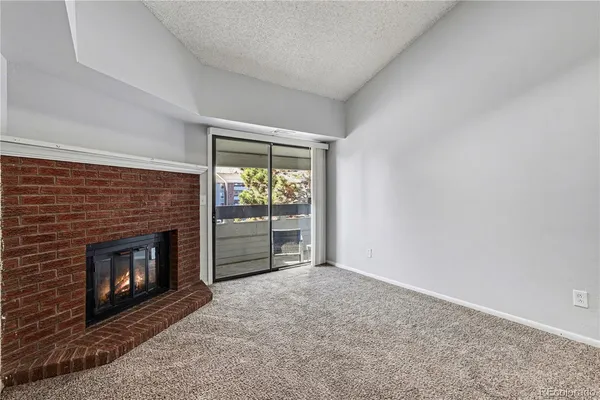 a view of empty room with a fireplace