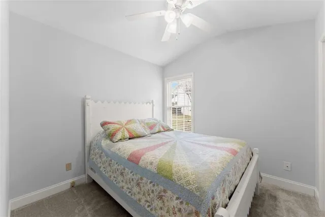 a bed sitting in a bedroom next to a window