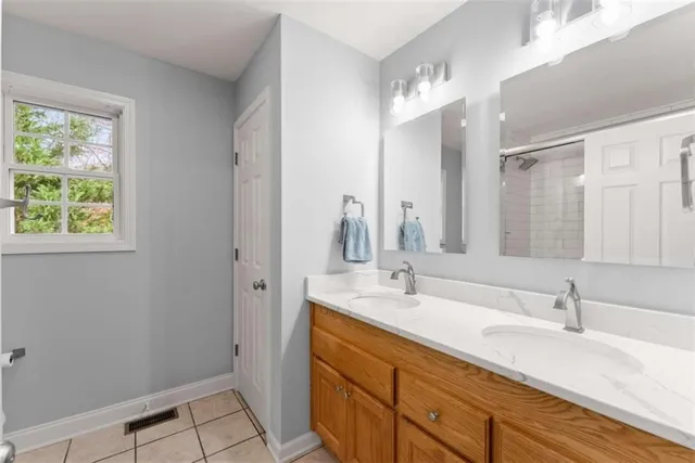 a bathroom with a double vanity sink and a mirror
