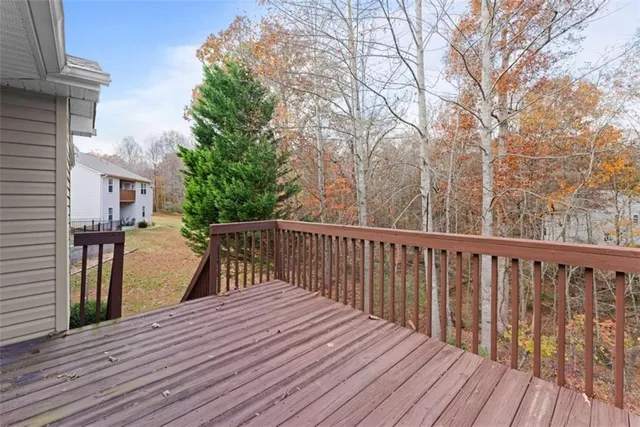 a balcony with wooden floor and fence