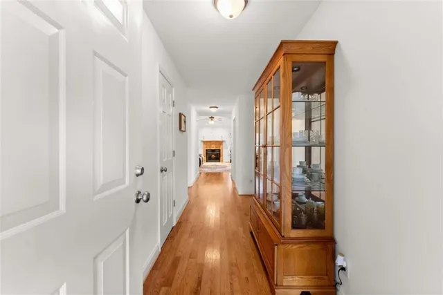 a view of a hallway with wooden floor and staircase