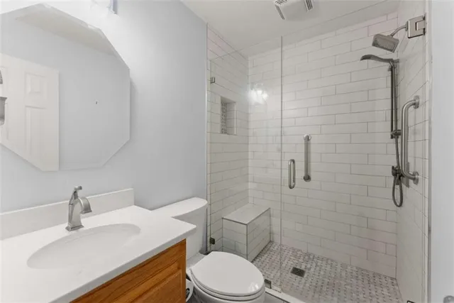 a bathroom with a sink toilet and shower