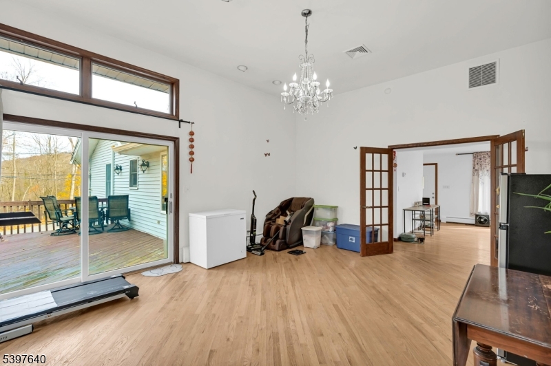 699 East Shore Road West Milford, NJ 07421 - Photo 13 of 50 a view of a livingroom with furniture a fireplace wooden floor and windows
