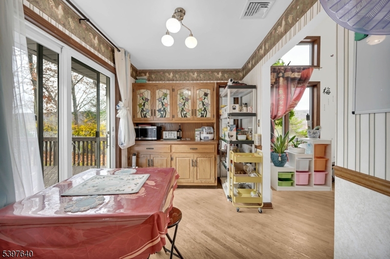 699 East Shore Road West Milford, NJ 07421 - Photo 17 of 50 a dining room with wooden floor and large windows
