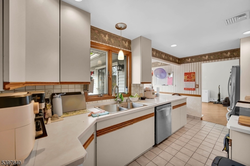 699 East Shore Road West Milford, NJ 07421 - Photo 22 of 50 a large white kitchen with a large window and sink