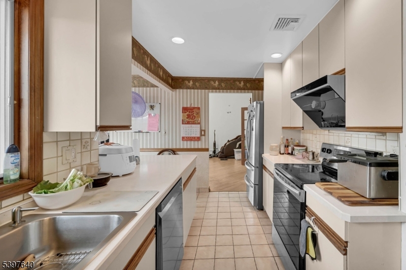 699 East Shore Road West Milford, NJ 07421 - Photo 23 of 50 a kitchen with a sink appliances and cabinets