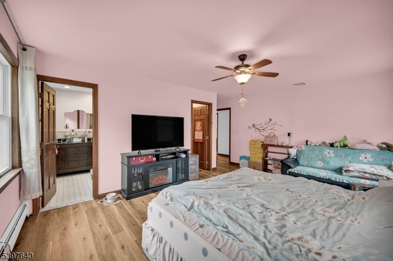 699 East Shore Road West Milford, NJ 07421 - Photo 27 of 50 a bedroom with a bed and a flat screen tv