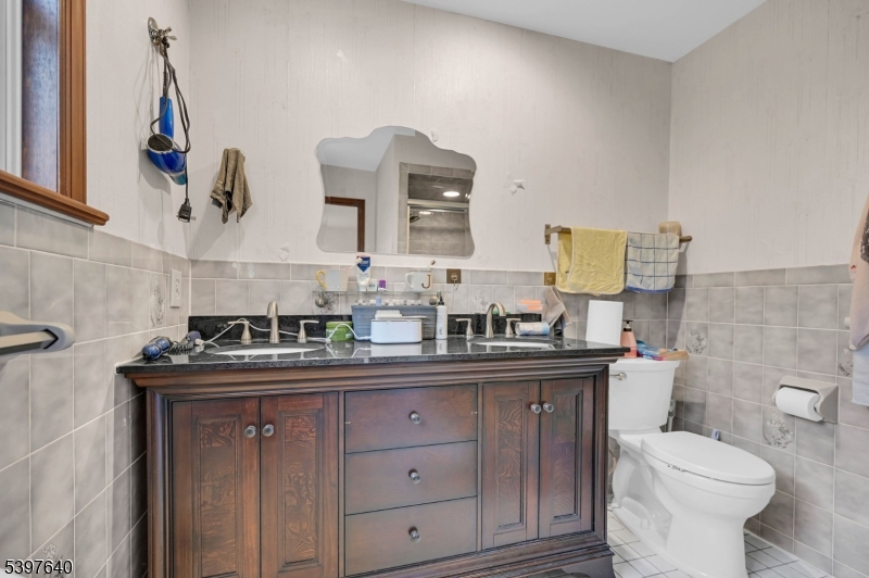 699 East Shore Road West Milford, NJ 07421 - Photo 28 of 50 a bathroom with a toilet sink and mirror
