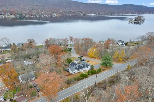 an aerial view of a house with a lake view