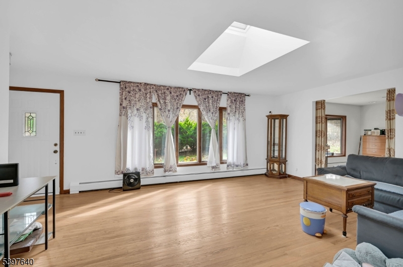 699 East Shore Road West Milford, NJ 07421 - Photo 7 of 50 a view of an empty room with wooden floor and a window