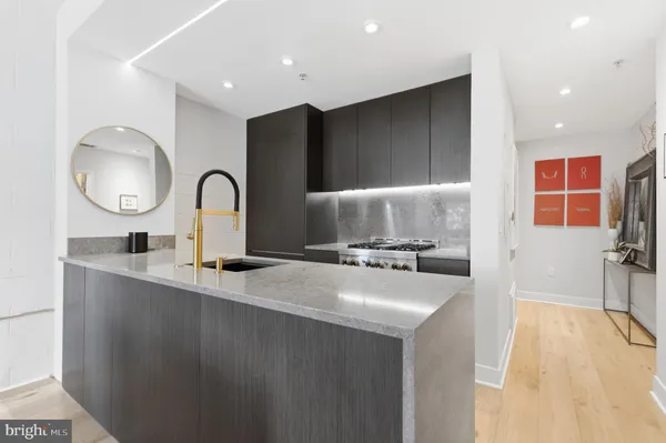 a kitchen with sink a stove and cabinets