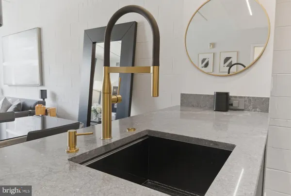 a kitchen with a sink a counter space appliances and cabinets