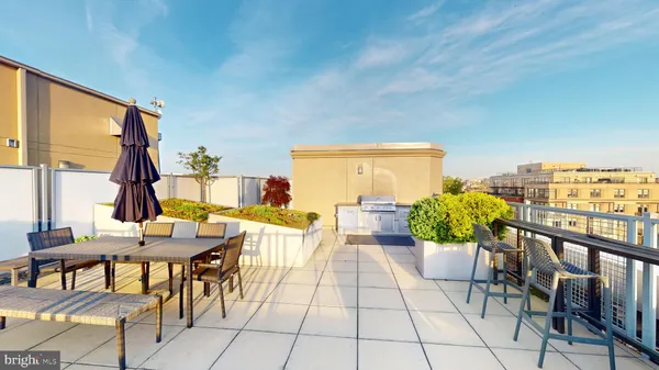 a view of an outside dining space with furniture