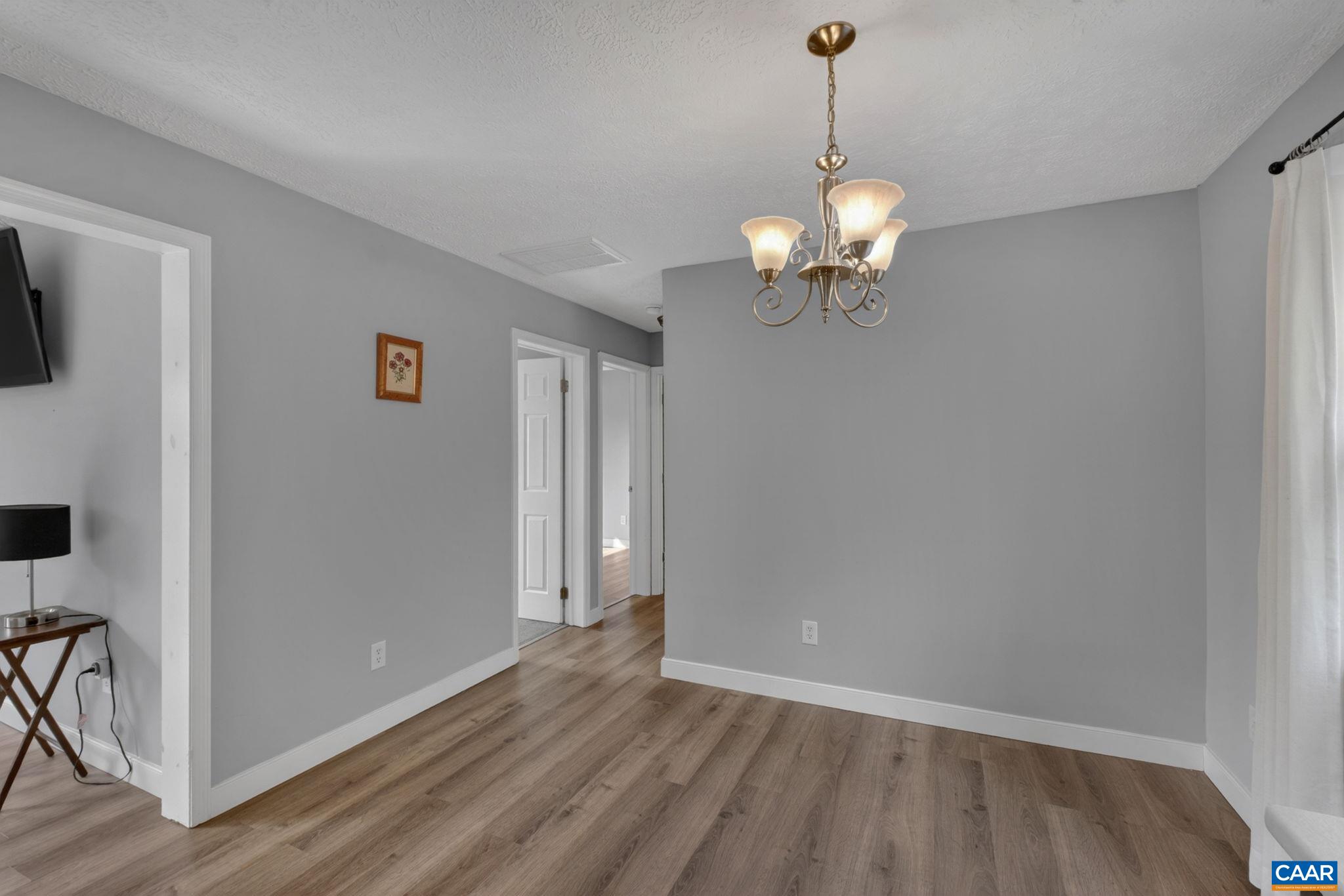 673 Cedar Lane Road Palmyra, VA 22963 - Photo 19 of 47 a view of a room with wooden floor chandelier fan and windows
