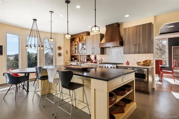 a kitchen with a table chairs stove and kitchen view