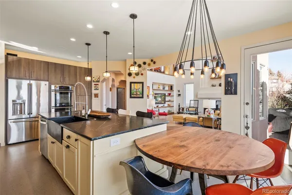 a kitchen with stainless steel appliances granite countertop a stove a sink and a refrigerator