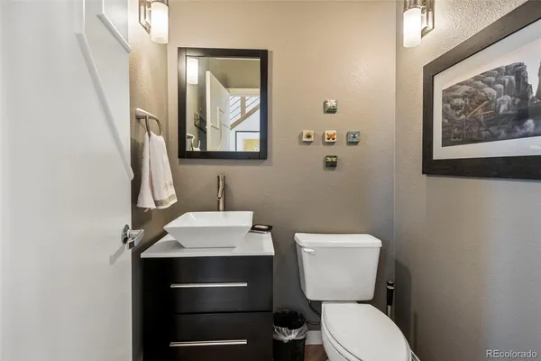 a bathroom with a toilet a sink and mirror