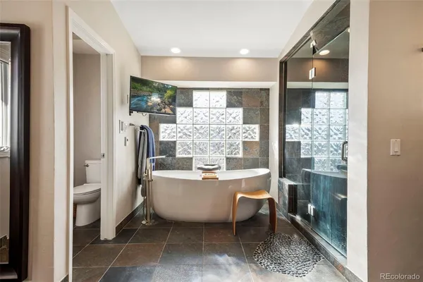 a room with a chandelier and fireplace