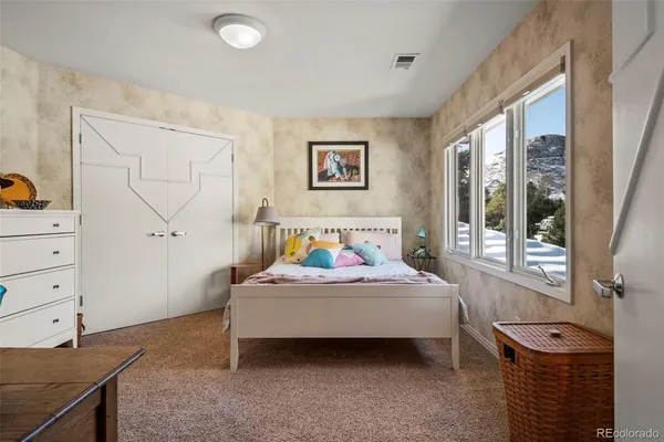 a bedroom with a bed and with furniture