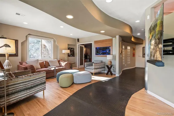 a living room with furniture a rug and a large window