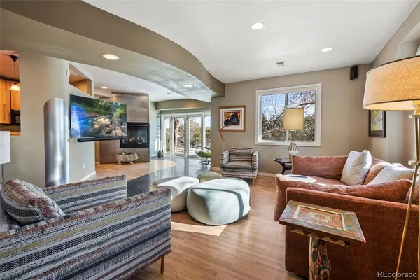 a living room with furniture a lamp and a rug