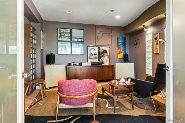 a living room with furniture a flat screen tv and a window