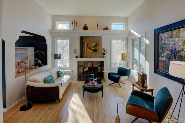 a living room with furniture and a fireplace