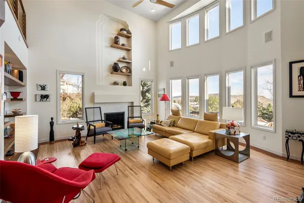 a living room with furniture large window and a fireplace