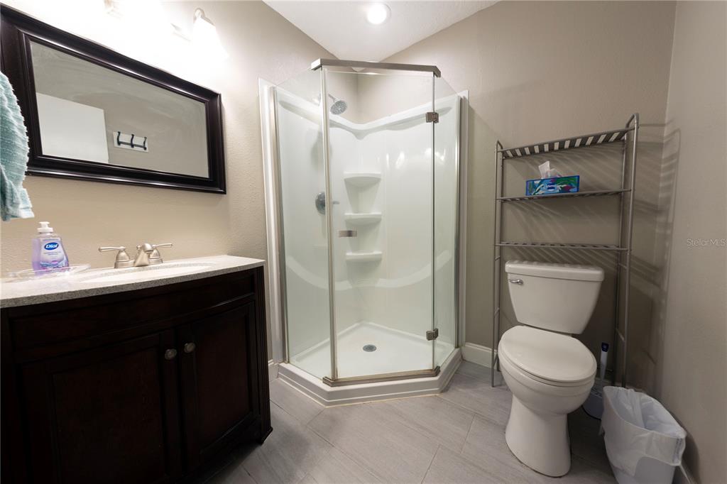 232 North Ridgewood Avenue, Unit 3A Edgewater, FL 32132 - Photo 13 of 19 a bathroom with a toilet sink shower and mirror