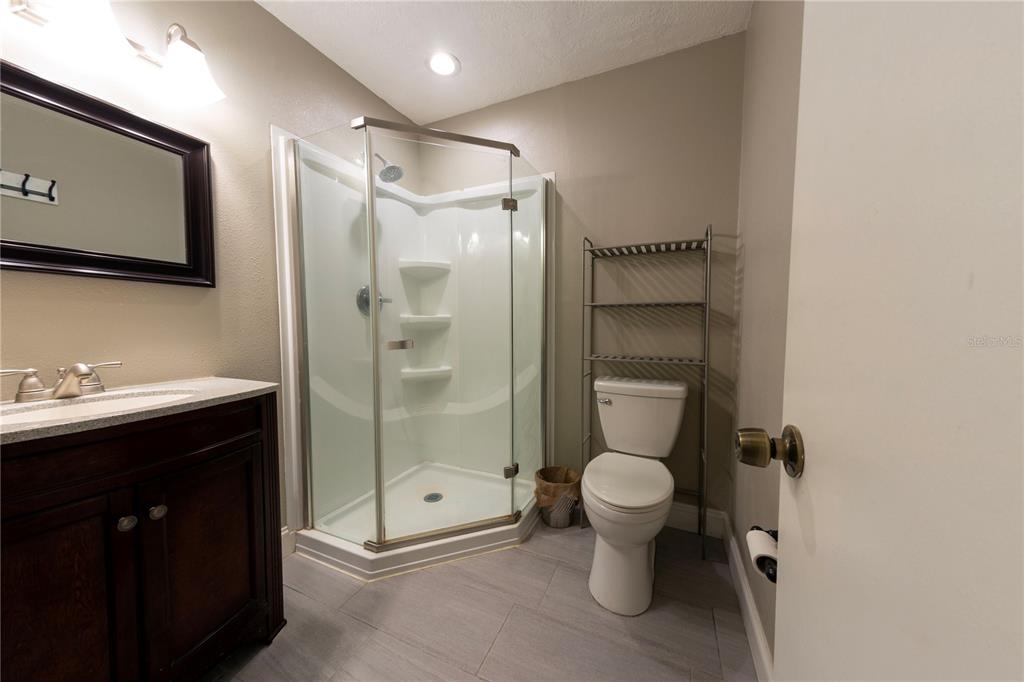 232 North Ridgewood Avenue, Unit 3A Edgewater, FL 32132 - Photo 13 of 19 a bathroom with a toilet sink and a shower