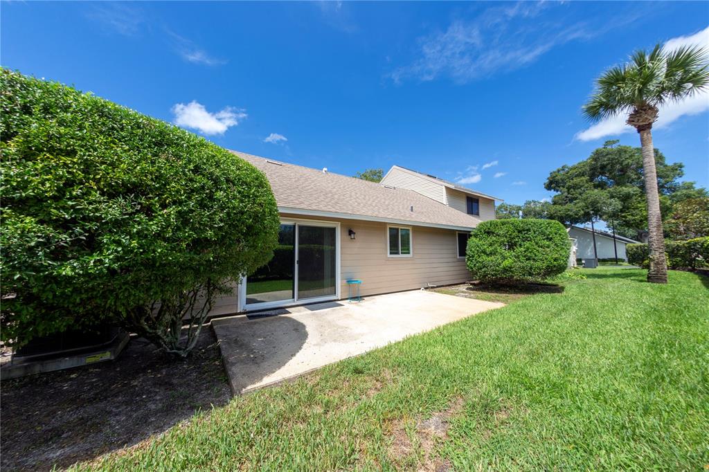 232 North Ridgewood Avenue, Unit 3A Edgewater, FL 32132 - Photo 15 of 19 a front view of a house with a yard and garage