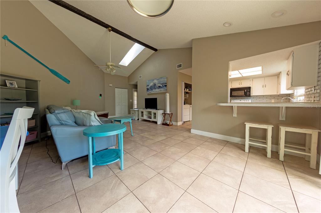 232 North Ridgewood Avenue, Unit 3A Edgewater, FL 32132 - Photo 5 of 19 a living room with furniture a dining table and a fireplace