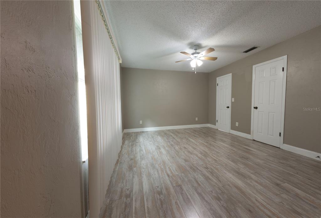 232 North Ridgewood Avenue, Unit 3A Edgewater, FL 32132 - Photo 8 of 19 wooden floor in an empty room with a window
